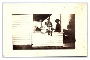 Family With Children Sitting On Porch Real Photo Postcard