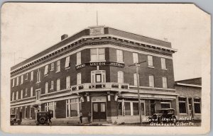 Grand Union Hotel Athabasca AB 1928 Edmonton Ex Slogan RPPC Postcard H82 as is