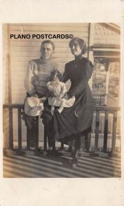 EARLY 1900'S COUPLE WITH VINTAGE DOLL RPPC REAL PHOTO POSTCARD