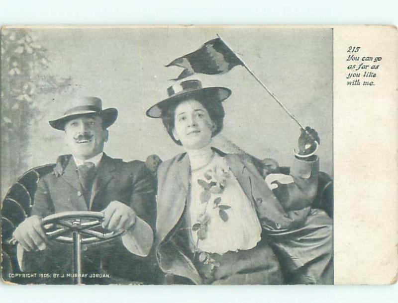 1905 WOMAN WAVES FLAG WHILE HUSBAND DRIVES VERY OLD CAR AB8307