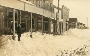 c1910 RPPC Snowy Street Scene w/ Storefronts Marked Virginia City? unposted nice