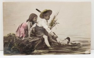 RPPC Adorable Children Sits on Rock Feeding the Duck in Water Photo Postcard C4