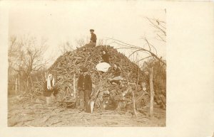 RPPC Postcard People on Giant Pile Of Cut Firewood & Loading Tiny Wagon