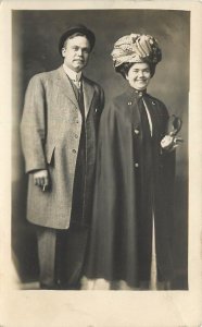 c1910 RPPC Happy Woman in Cloak & Huge Turban Hat w/Smoking Man, Unknown US