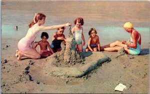 Sunny Day On The Beach Children Building Sand Castle