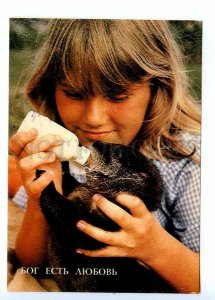 496913 USSR 1991 year God is love girl feeding otter postcard