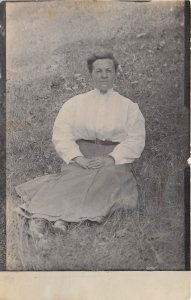 c1908 RPPC Real Photo Postcard Woman Skirt Blouse Sitting Grass Hill