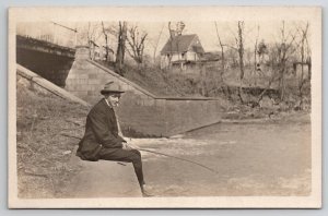 RPPC Man in Suit Smoking and Fishing on Stone Wall at Bridge Postcard F29