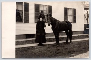 Keene New Hampshire~Woman in Winter Coat Holds Black Horse~Home~1910 RPPC 