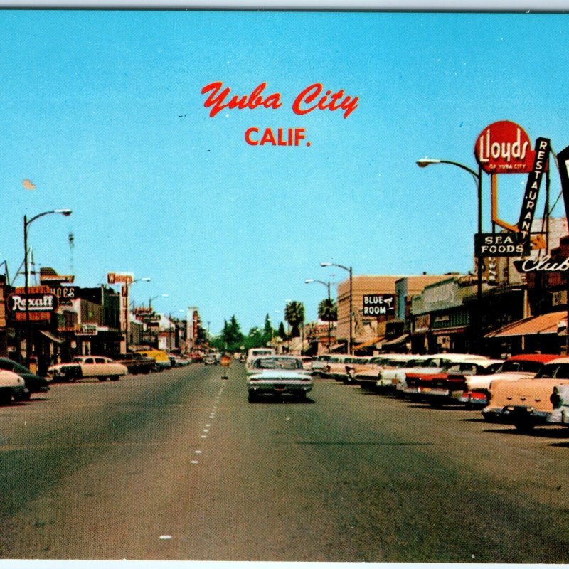 c1960s Yuba City, CA Main St Downtown Fritz Vibe Postcard Lloyds Rexall Cali A91