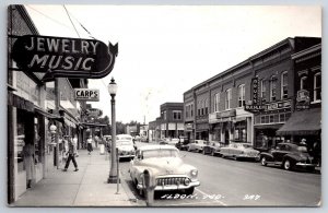 Eldon MO Jewelery/Music Store~Krogers~Buehler's~c1950 Roadmaster~Studebaker RPPC
