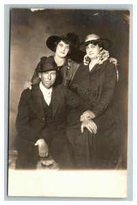 Vintage 1910's RPPC Postcard Photo of a Man and Two Women in Hats