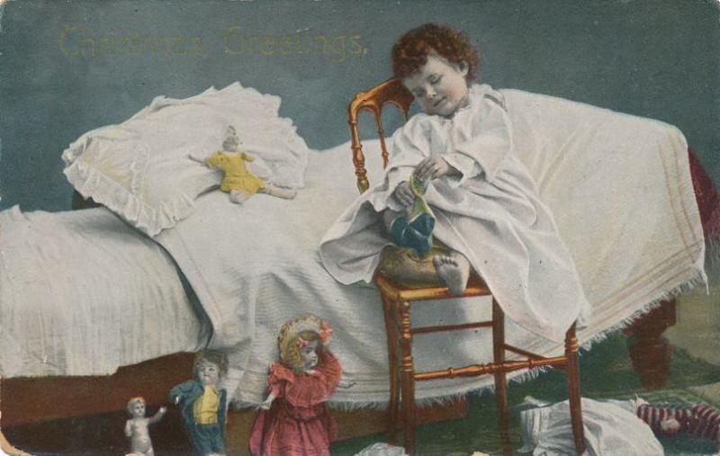 Christmas Greetings - Child on bed removing Sock - DB