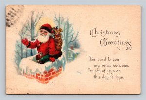 c1921 Santa Claus Waving From Chimney Bag Of Toys Christmas Greetings Postcard