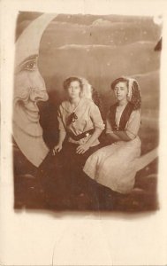 Two Women Posing on Moon Backdrop Two Women Posing on Moon Backdrop