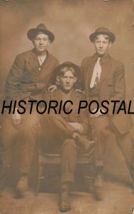 THREE BROTHERS ? POSING AT DIFFERENT TIMES-LOT OF 2 REAL PHOTO POSTCARDS