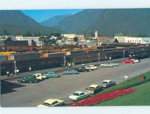 1960's OLD CARS AND PARKING LOT BY THE TRAIN Revelstoke BC F9256