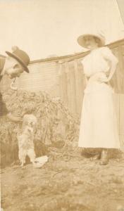 Real Photo Postcard; Woman, Man w Pipe & Lap Dog Maltese? Posted 1912