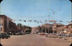 Thermopolis WY Broadway Street Scene Cars Stores Postcard