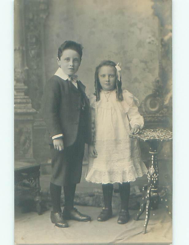 rppc 1920's GIRL WITH CURLS IN HER HAIR STANDS WITH BIG BROTHER AC8542