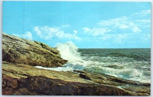 Postcard - Rolling surf breaks against rugged coastline