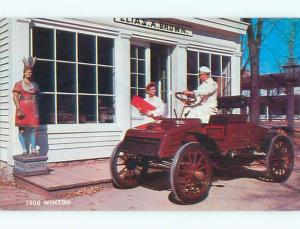 Unused 1970's postcard ANTIQUE CIGAR STORE INDIAN BESIDE 1906 WINTON CAR k9064