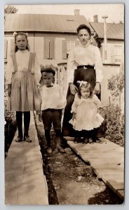 Edwardian Mother with Darling Children Plank Sidewalk in Yard RPPC Postcard L44