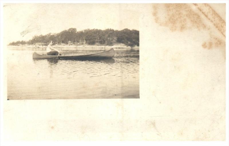 21318   Wood Canoe with paddler on lake RPC