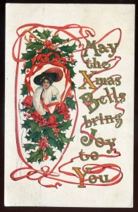 h2298 - CHRISTMAS Postcard 1911 Embossed Gilded Tree Bells Woman