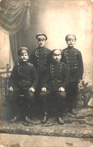 Four Russian Soldiers in 1910, Card has crease, Real Photo Postcard