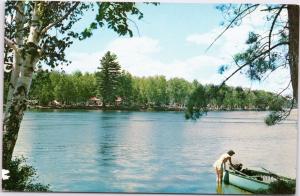 Woman getting into rowboat at Fish Creek public campground in Adirondacks