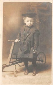 RPPC BOY WITH VELOCIPEDE BICYCLE STUDIO REAL PHOTO POSTCARD (c. 1910)