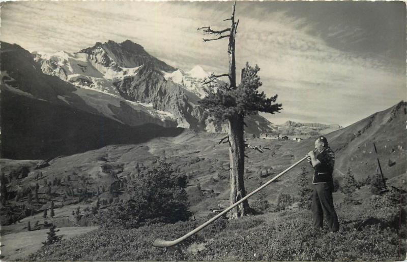 Switzerland alpine horn blower traditional folk music instrument rppc