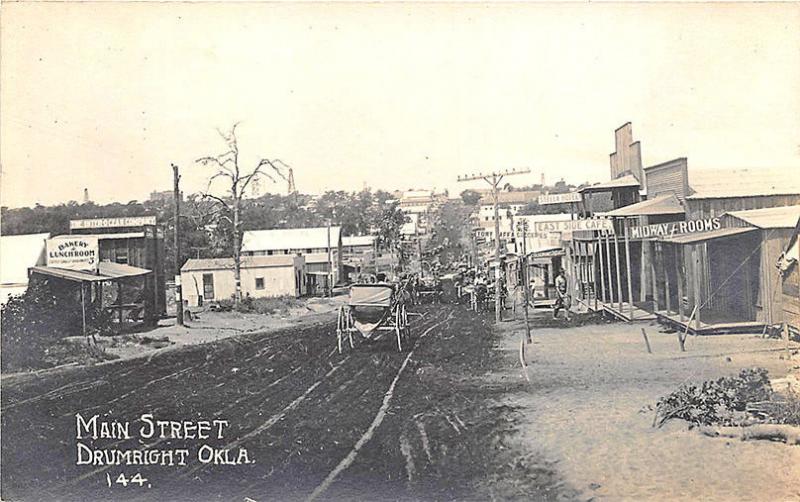 Drumright OK Dirt Street View Store Fronts Horse & Wagons RPPC Postcard