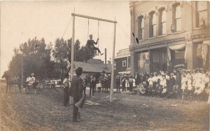 J33/ Sauk City Wisconsin RPPC Postcard c1910 High Wire Act Man Chair Crowd 293
