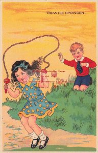 Young Girl Skipping Rope While Young Boy Plays with a Ball, Touwtje Springen!