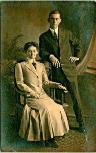 RPPC Studio View Dapper Young Man in Suit Well Dressed Sitting Woman Postcard