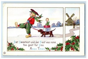 c1910's Christmas Dutch Boy Pulling Dachshund Dog Windmill Holly Winter Postcard