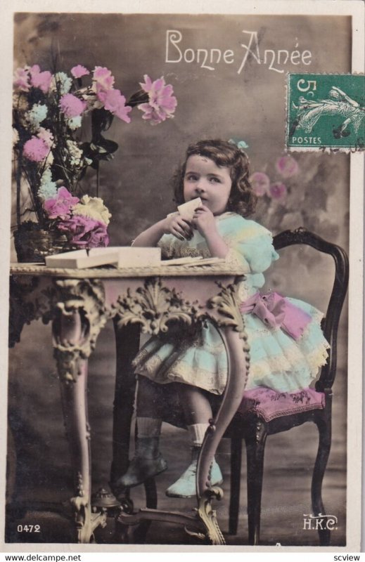 RP: NEW YEAR, 1910-20s; Bonne Annee, Little girl sitting at table sealing h...