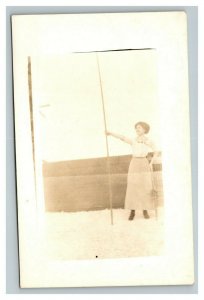 Vintage 1910's RPPC Postcard Photo of Woman Holding on to Pole