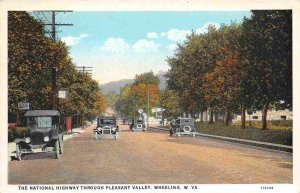 National Highway Through Pleasant Valley Cars Wheeling West Virginia postcard