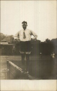 Trenton MO (Written on Back) Man in Odd Shorts RR Train & Home c1910 RPPC