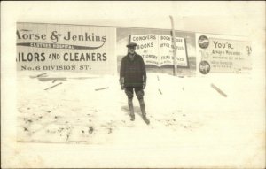 Man in Front Advertising Signs on Fence Amsterdam NY on Back c1920 RPPC #1