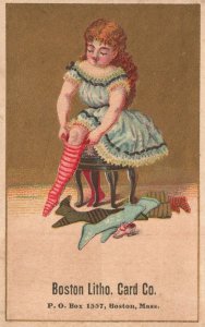 1880s-90s Boston Litho Card Co. Boston MA Girl Trying on Stockings Trade Card