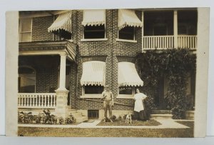 RPPC Man & Woman with Dog Brick Row Home Real Photo Postcard N15