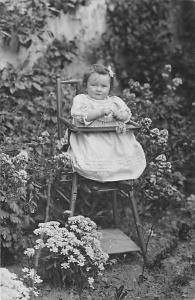 Little girl in high chair Child, People Photo Writing on back 