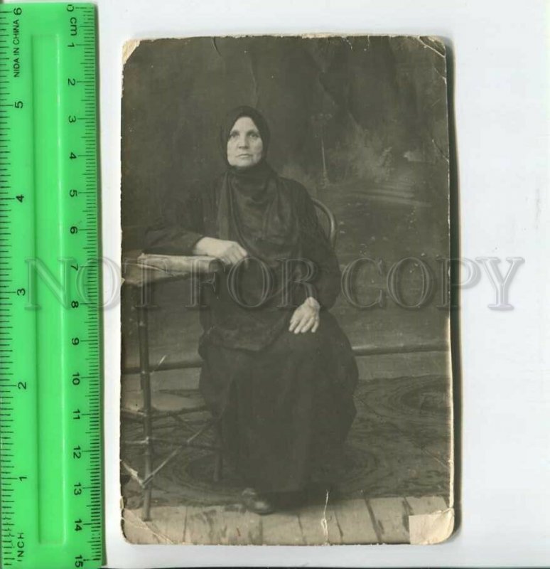 452611 RUSSIA granny in mourning on a chair Old photo