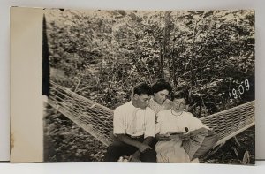 RPPC Young People, One Showing Her Teeth Posing on Hammock c1909 Postcard G6