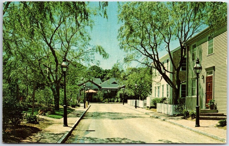 VINTAGE POSTCARD HARBOR HOUSE AND TREE-LINED STREET AT OLD NANTUCKET MASS