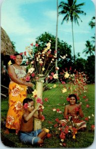 Decorating the stands outside their fales with flowerpieces Hawaii Postcard